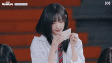 a girl is wearing a white shirt and tie and the word runup is on the bottom right