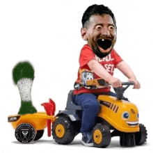 a child is riding a toy tractor with a soccer ball attached to the back .