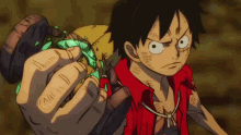 monkey d luffy from one piece is holding a green object with the letter a on it