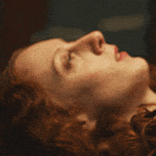 a close up of a woman 's face looking up
