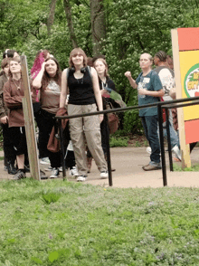 a group of people are standing in front of a sign that says ' african sky ' on it
