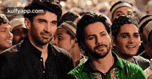 two men are standing next to each other in a crowd .