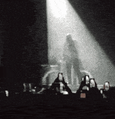 a group of people taking pictures of a man on a stage