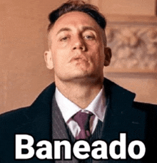 a man in a suit and tie with the words baneado written on the bottom