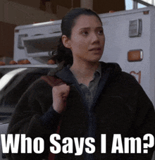 a woman standing in front of an ambulance with the words who says i am