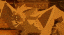 a bat is flying through the air with its wings outstretched in a dark room .