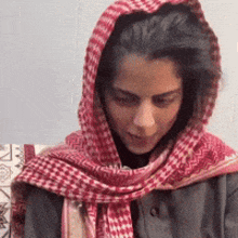 a woman wearing a red scarf around her head