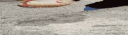a person is standing on a concrete surface with their foot on a puddle .