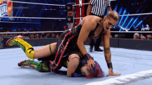 two women are wrestling in a wrestling ring with the words wrestlemania on the bottom