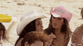 a group of women wearing cowboy hats on a beach with a watermark that says red 30