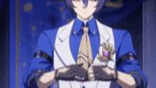 a man in a blue suit and tie is holding his hands together in front of his chest .