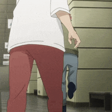 a man in a white shirt and red pants stands next to a man in a blue shirt