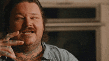 a man with a tattoo on his chest that says " attitude rock "