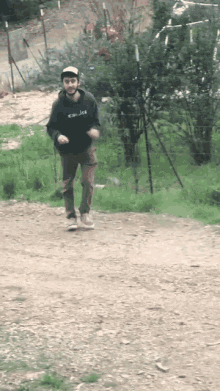 a man wearing a hoodie that says ' columbia ' on it is running