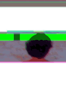a blurry picture of a person with purple hair standing in front of a green and pink background .
