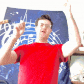 a man in a red shirt is standing in front of a music sheet