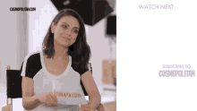 a woman sitting in a chair with a sign that says cosmopolitan