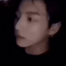 a blurry picture of a person dancing in the dark .
