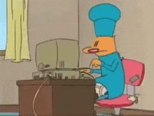 a cartoon cat is sitting at a desk in front of a computer .
