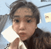 a girl wipes her face with a towel and has the hashtag @ruuna_070 on the bottom