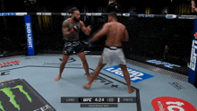 two men are fighting in a ring with bud light advertisements