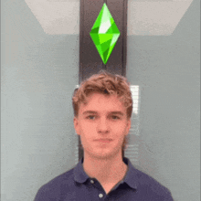 a young man with his eyes closed stands in front of a green diamond