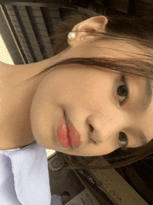 a close up of a girl 's face with a sign in the background that says ' yamaha ' on it