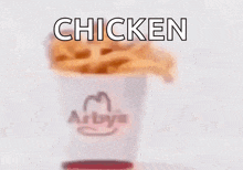a blurry picture of a chicken sandwich with the word chicken written in white letters .
