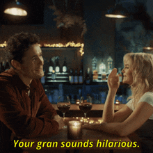 a man and a woman are sitting at a table with wine glasses and a caption that says your gran sounds hilarious