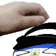 a person 's hand is reaching out towards a drawing of a person 's face .