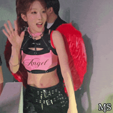 a girl wearing a pink top that says angel
