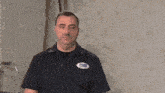 a man wearing a blue shirt with a patch on it that says national plumbing supply