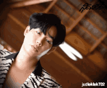 a man wearing a zebra print shirt with judleklek702 written below him