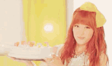 a woman with red hair is holding a tray of food .