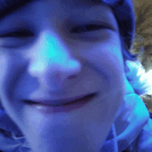 a close up of a child 's face with a blue background