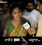 a woman is being interviewed by a man with a gun in front of her