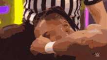 a drawing of a referee holding a wrestler 's head with the w logo in the corner
