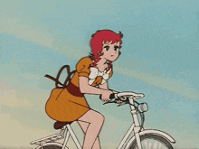 a woman with red hair is riding a bike
