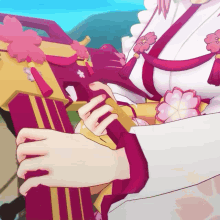 a close up of a person 's hand holding a red and gold object