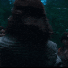 a woman wearing a hat is making a funny face in the dark