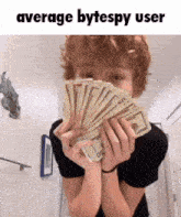a man is holding a bunch of money in front of his face and the caption says average bytespy user