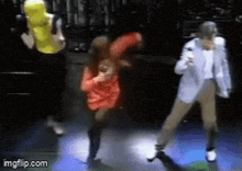 a group of people are dancing on a stage with imgflip.com at the bottom of the screen