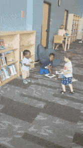 three young boys are playing in a library with bookshelves full of books