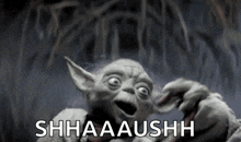 yoda from star wars is making a funny face and saying shh aa u s h .