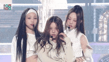 a group of girls are standing on a stage in front of a sign that says fox live