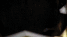 a close up of a candle being lit up in the dark
