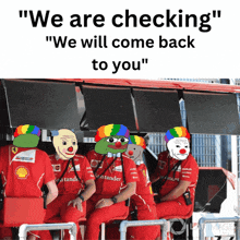 a group of people wearing red santander shirts are sitting in a row