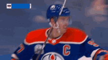 a hockey player wearing a jersey with the letter p on it
