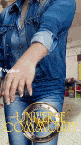 a woman wearing a denim shirt and jeans is standing in front of a sign that says universe community