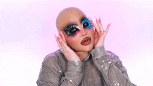 a woman with a bald head and a lot of makeup on her face